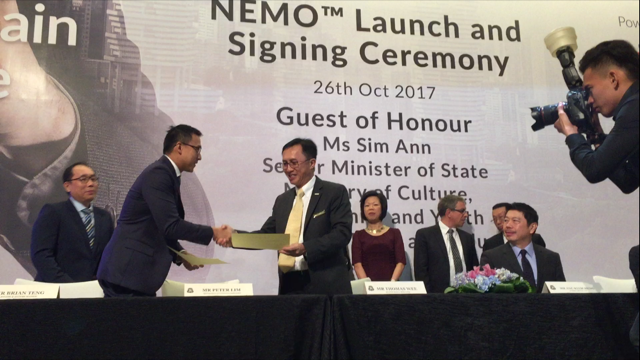 Brian Teng shaking hands with business man at NEMO Launch and Signing Ceremony