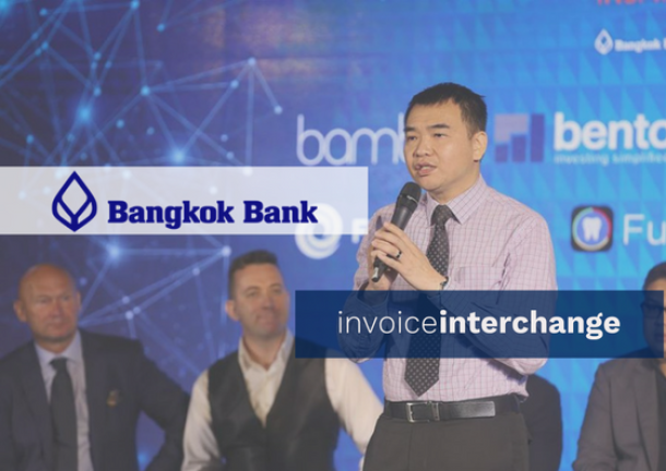 bangkok bank logo with invoiceinterchange logo infront of business man speaking at event